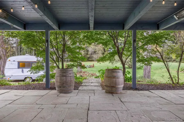 a view of an house with a yard and trees
