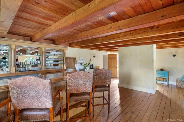 a dining room with furniture and wooden floor