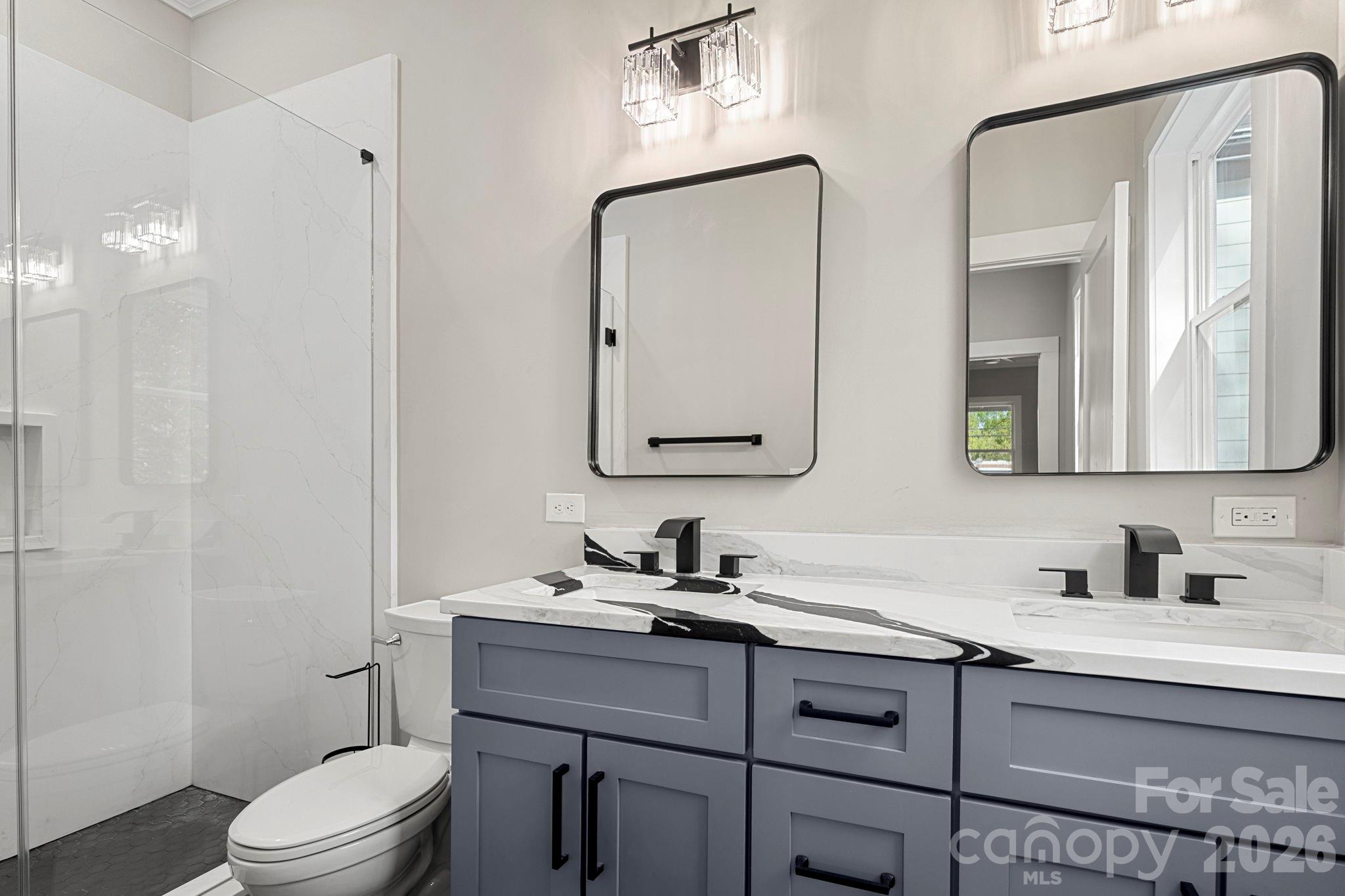 918 North New Hope Road Gastonia, NC 28054 - Photo 24 of 37 a bathroom with a toilet a sink a light fixture and a mirror
