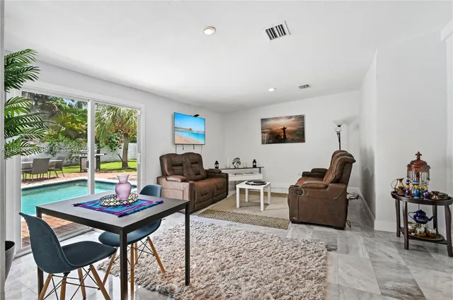 a living room with furniture a rug and a large window