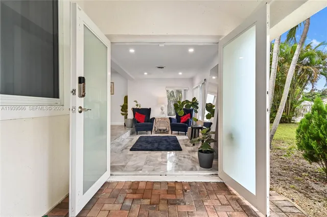 a hallway with lots of white furniture and a refrigerator