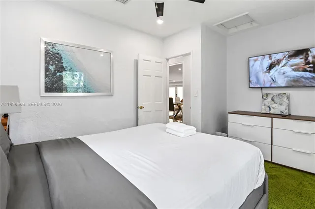 a bedroom with a bed and a painting on the wall