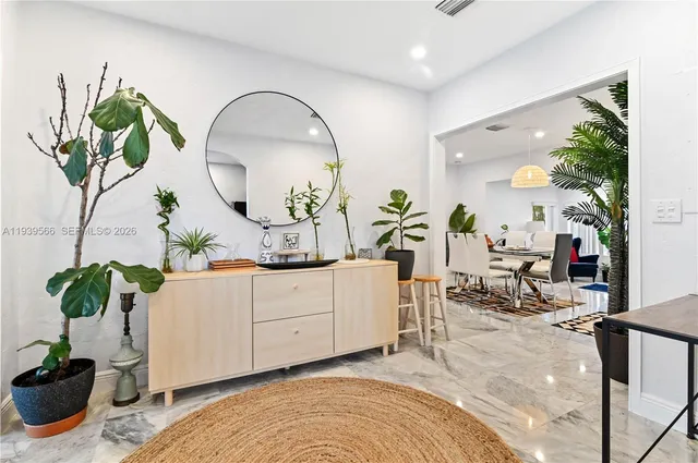 a living room with furniture and a potted plant