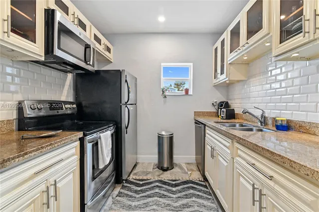 a kitchen with stainless steel appliances granite countertop a stove and a sink