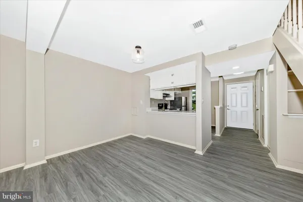 a view of entryway with wooden floor and stairs