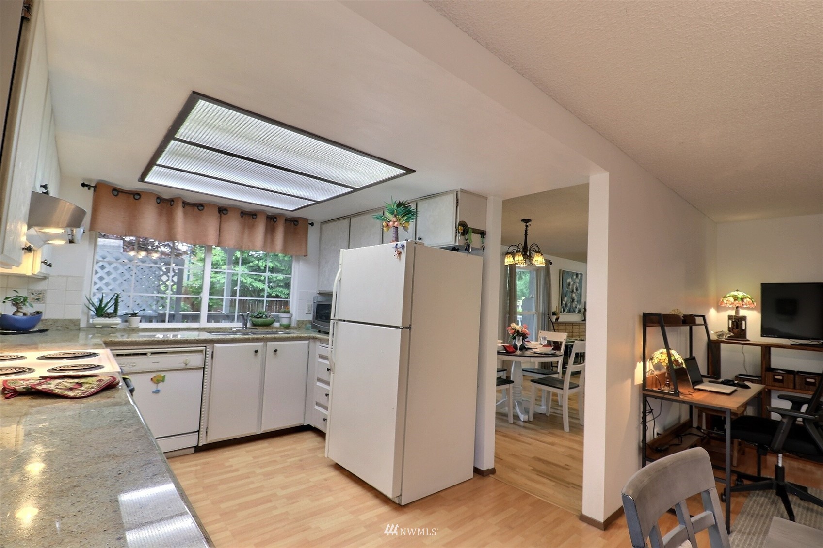 17234 139th Place Southeast Renton, WA 98058 - Photo 11 of 36 a kitchen with a refrigerator a stove a sink a dining table and chairs