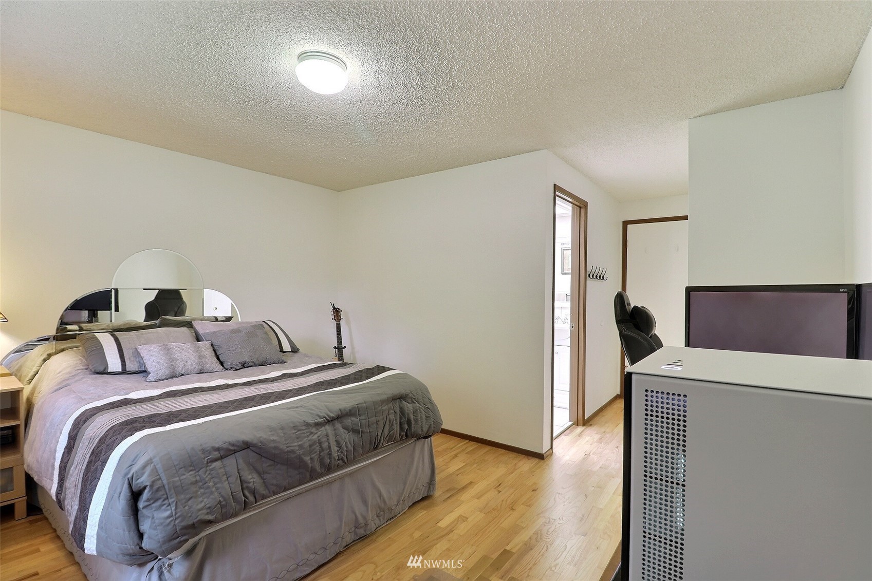 17234 139th Place Southeast Renton, WA 98058 - Photo 19 of 36 a bedroom with a bed and a view of kitchen