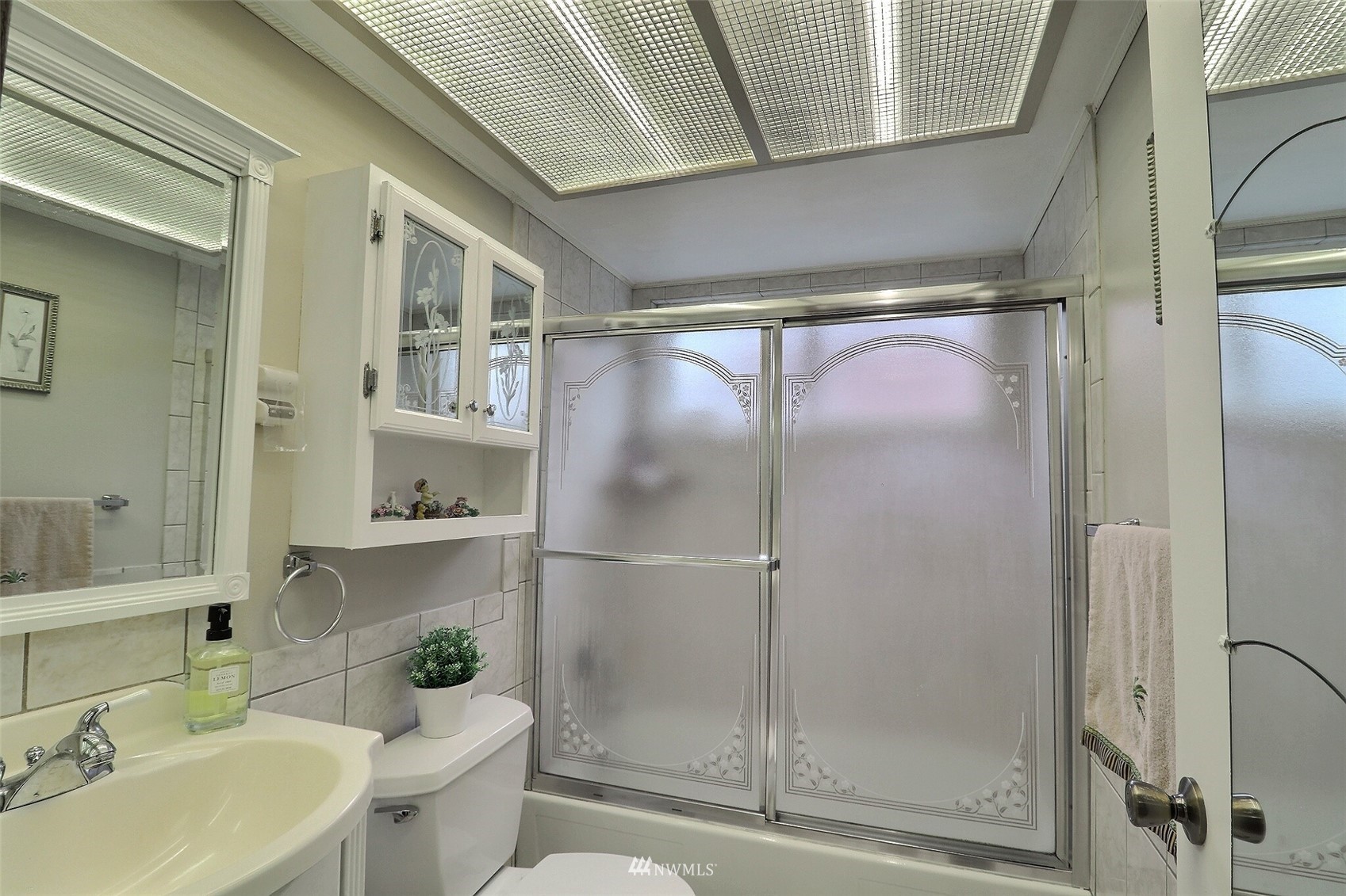 17234 139th Place Southeast Renton, WA 98058 - Photo 25 of 36 a bathroom with a shower sink vanity mirror and toilet