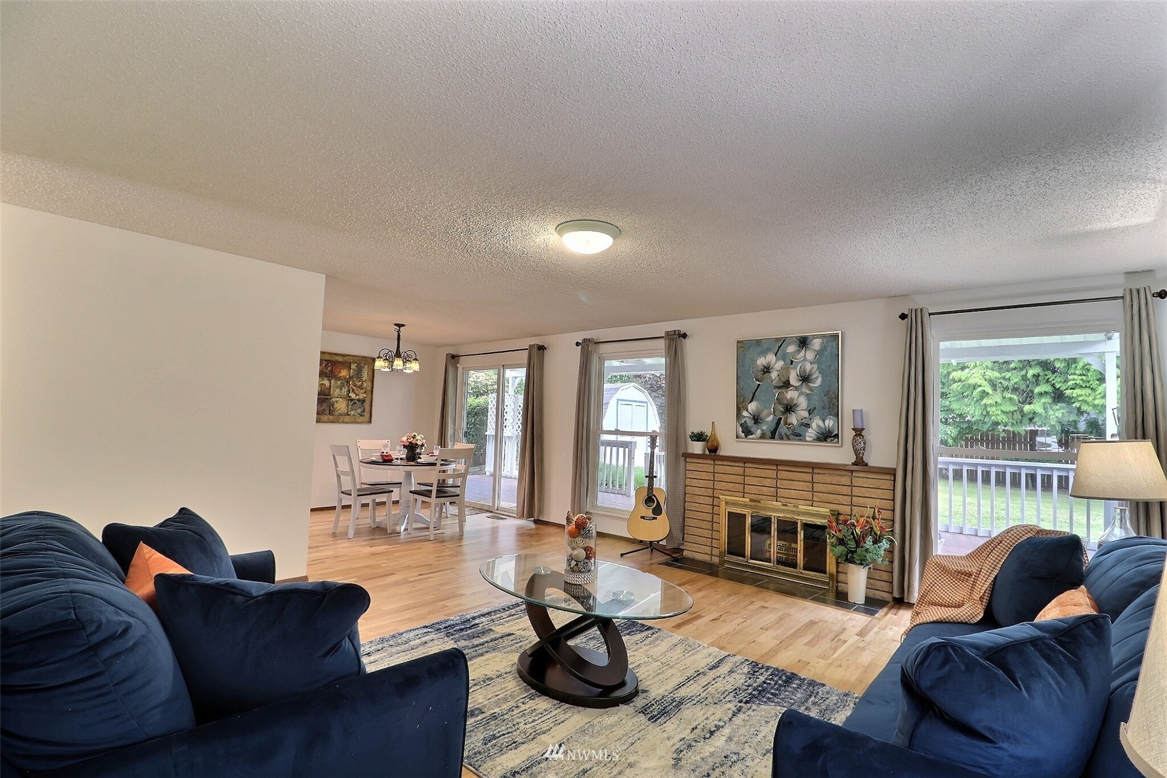 17234 139th Place Southeast Renton, WA 98058 - Photo 9 of 36 a living room with fireplace furniture and a wooden floor