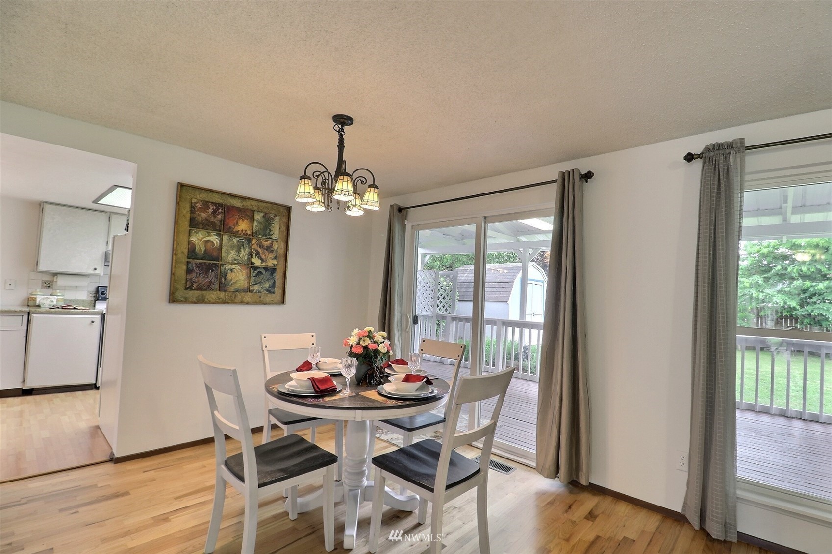 17234 139th Place Southeast Renton, WA 98058 - Photo 10 of 36 a view of a dining room with furniture window and wooden floor
