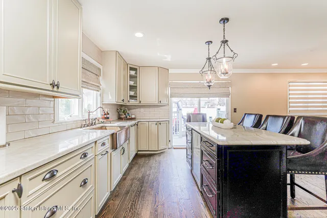 a kitchen with stainless steel appliances granite countertop a sink stove and cabinets