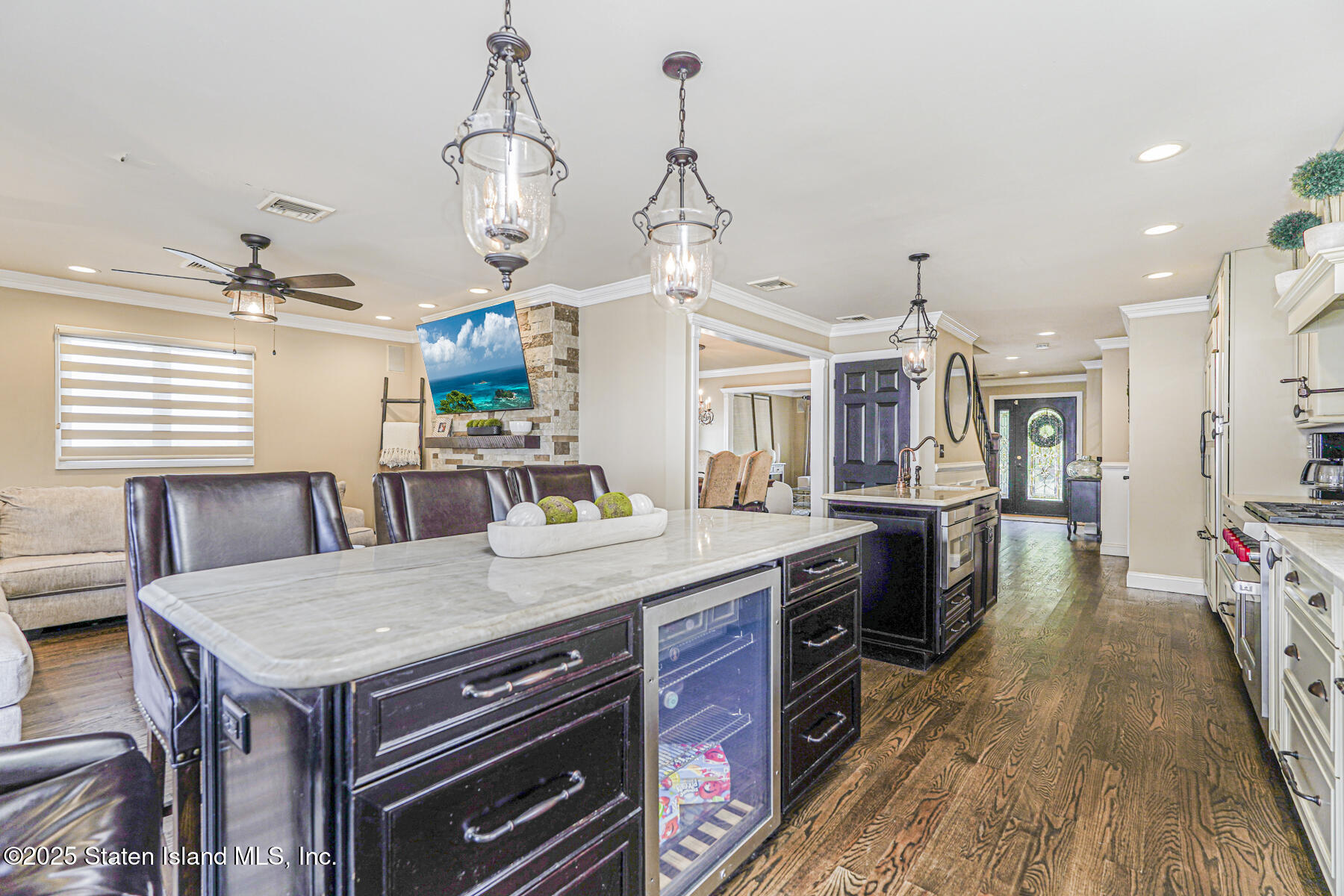 191 Rensselaer Avenue Staten Island, NY 10312 - Photo 15 of 36 a kitchen with a stove a sink dishwasher a kitchen island with wooden cabinets and floor