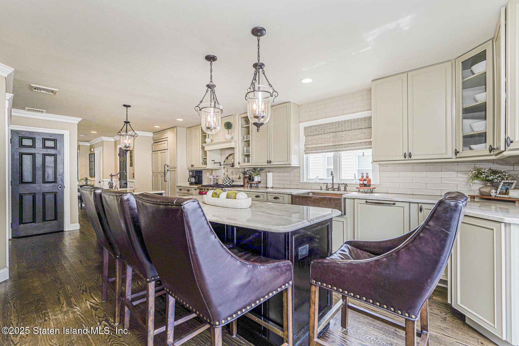 191 Rensselaer Avenue Staten Island, NY 10312 - Photo 17 of 36 a dining room with furniture a chandelier and wooden floor