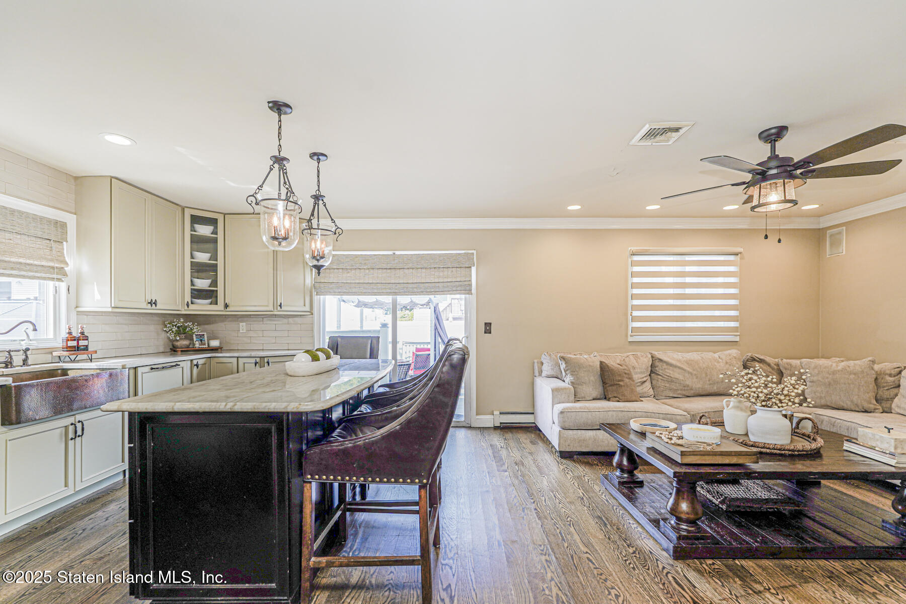 191 Rensselaer Avenue Staten Island, NY 10312 - Photo 20 of 36 a kitchen with a stove a sink dishwasher a dining table and chairs with wooden floor