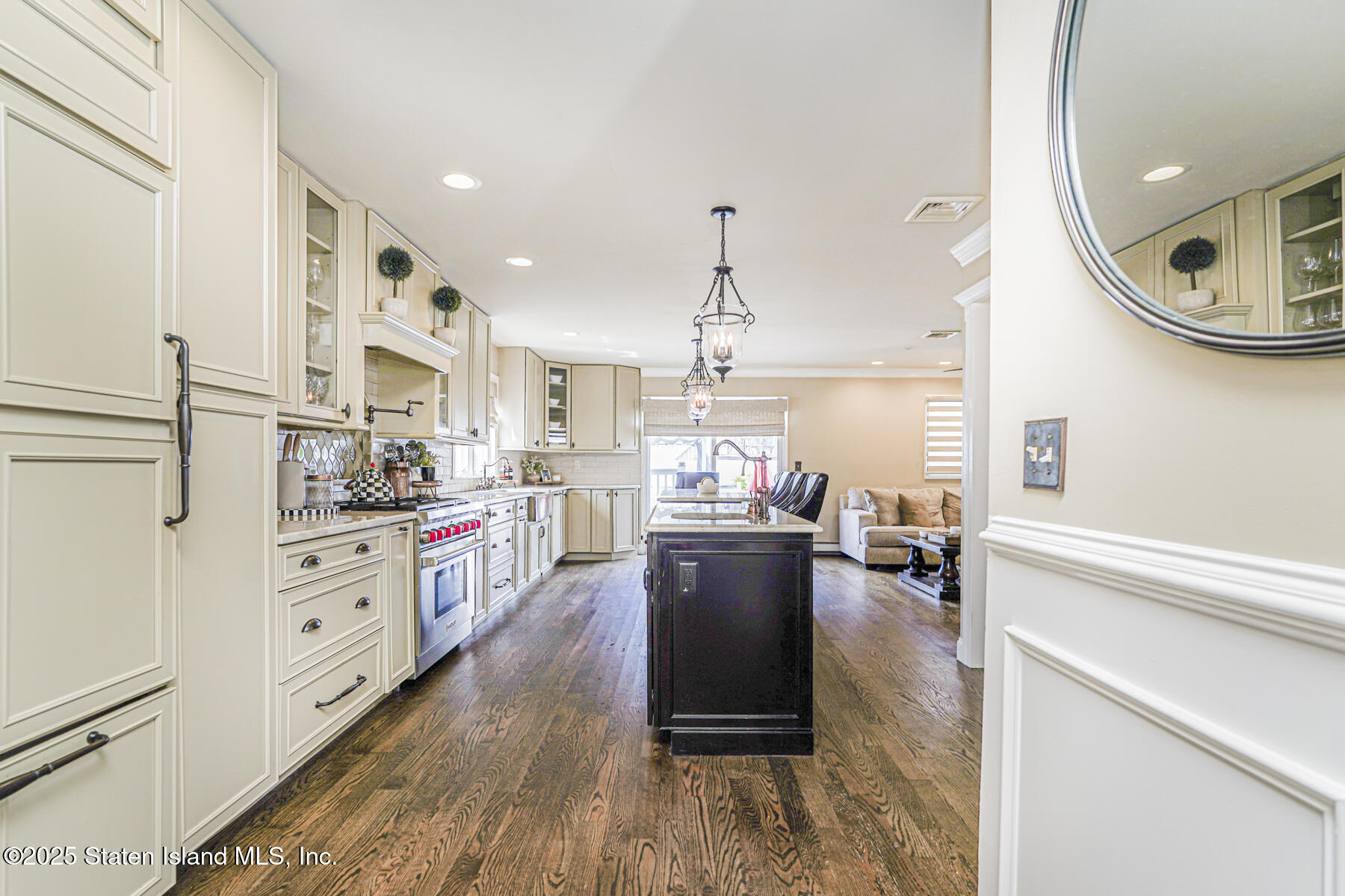 191 Rensselaer Avenue Staten Island, NY 10312 - Photo 21 of 36 a kitchen with stainless steel appliances kitchen island hardwood floor sink and stove