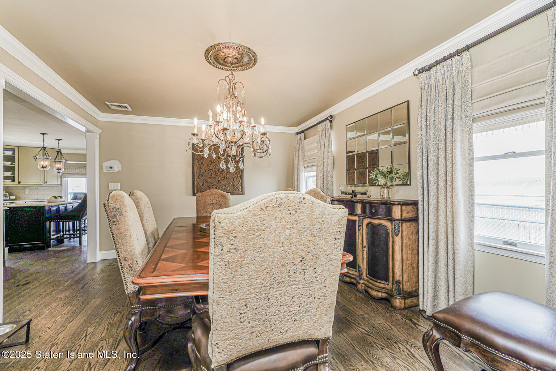 191 Rensselaer Avenue Staten Island, NY 10312 - Photo 24 of 36 a dining room with furniture a chandelier and wooden floor