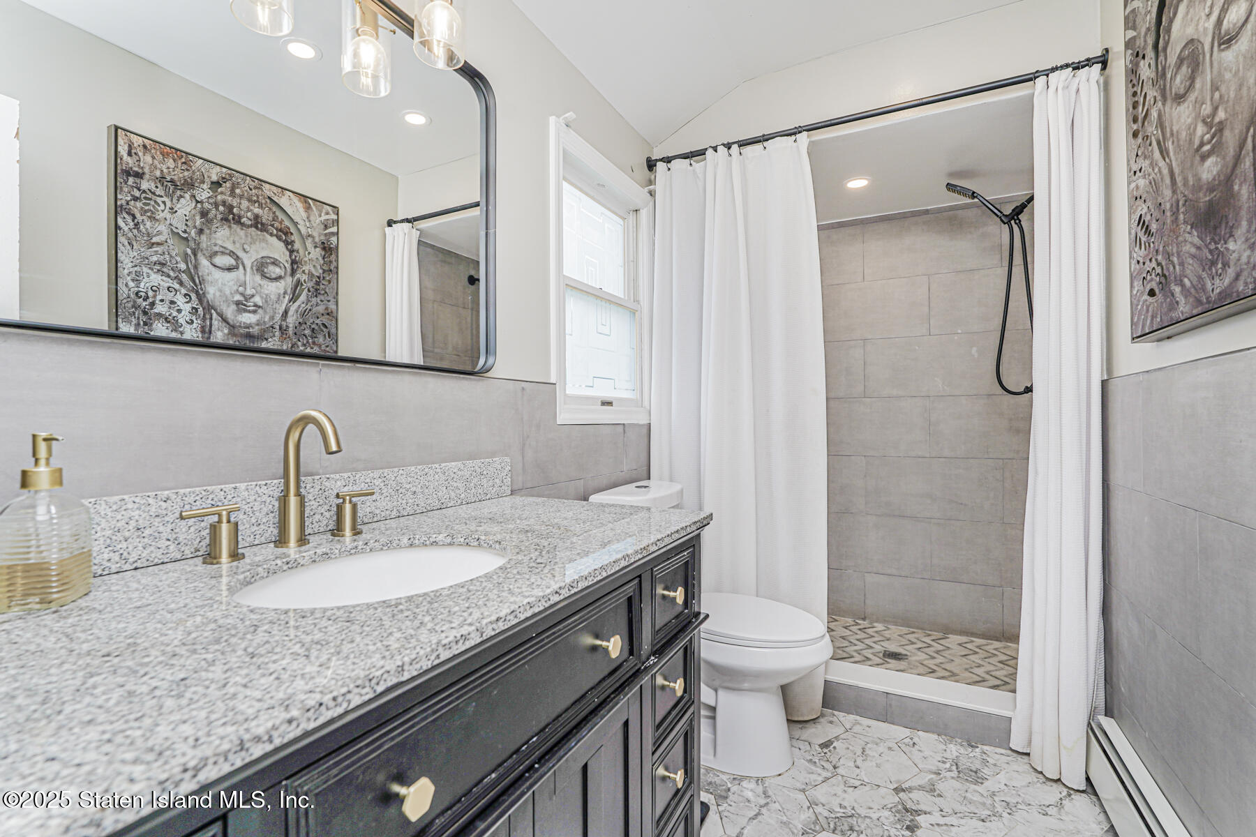 191 Rensselaer Avenue Staten Island, NY 10312 - Photo 28 of 36 a bathroom with a granite countertop sink a toilet and shower