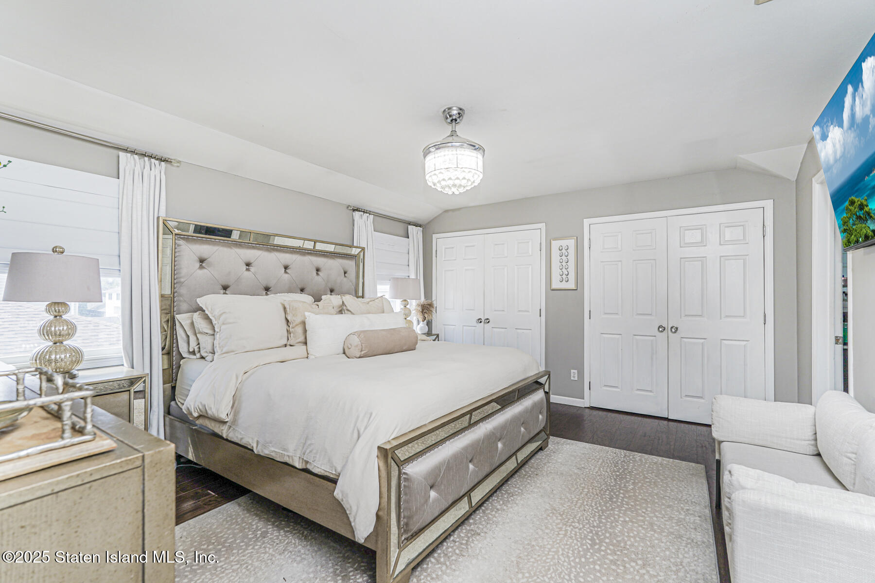 191 Rensselaer Avenue Staten Island, NY 10312 - Photo 31 of 36 a bedroom with a bed and a chandelier