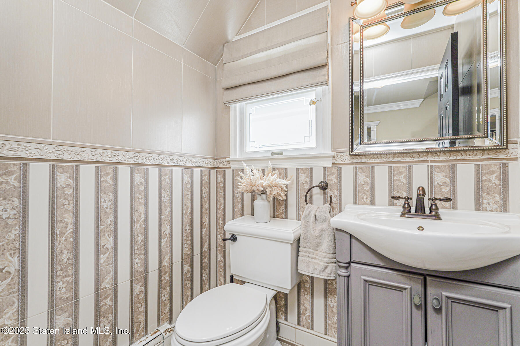 191 Rensselaer Avenue Staten Island, NY 10312 - Photo 34 of 36 a bathroom with a sink toilet and mirror