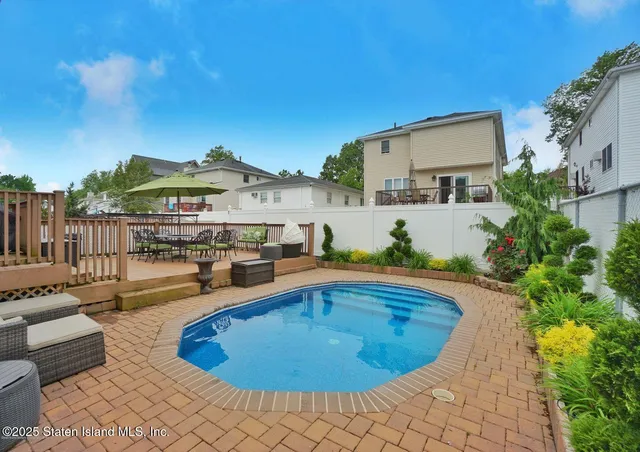 a swimming pool with outdoor seating and yard