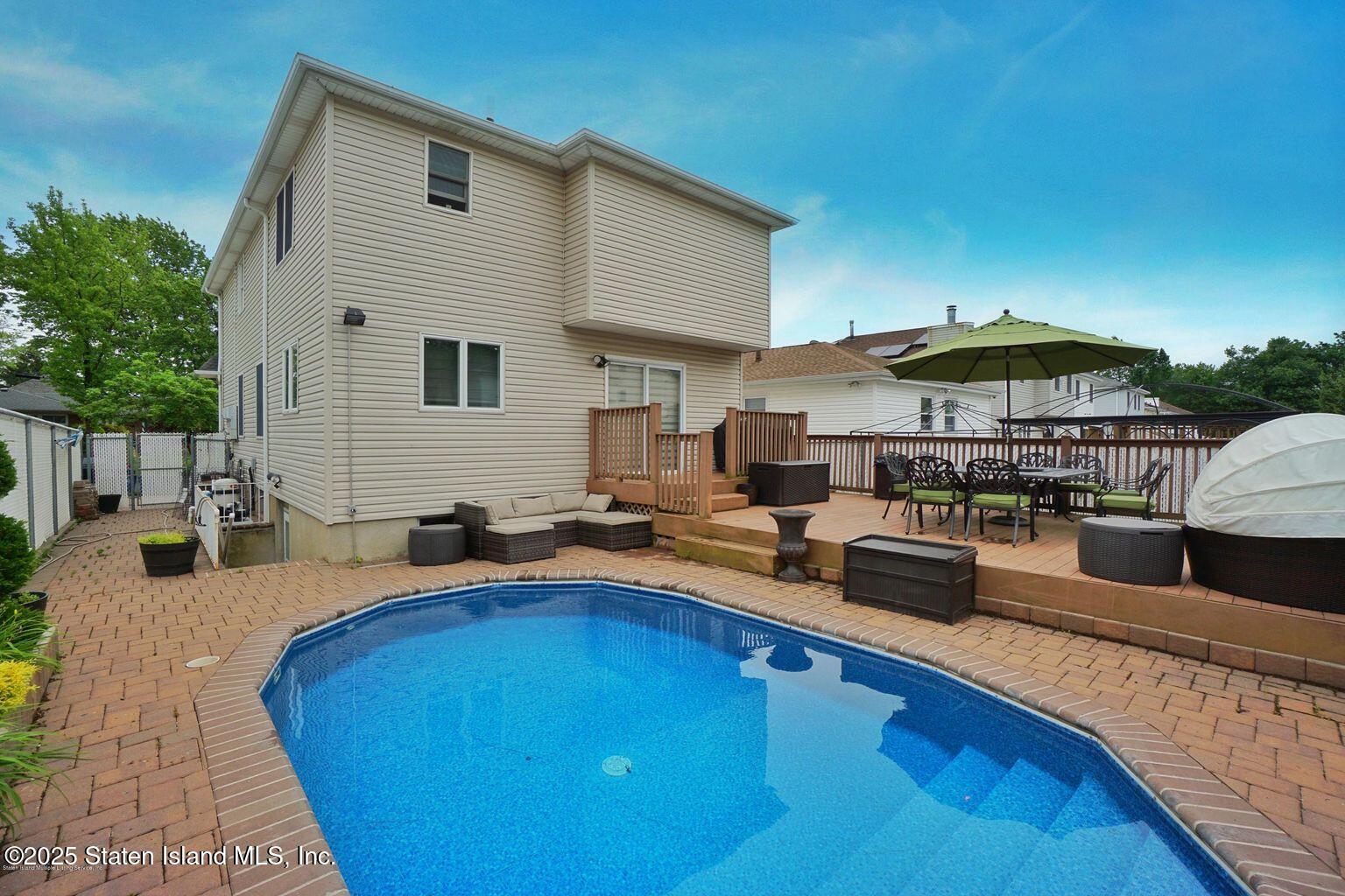 191 Rensselaer Avenue Staten Island, NY 10312 - Photo 36 of 36 a swimming pool with outdoor seating and yard