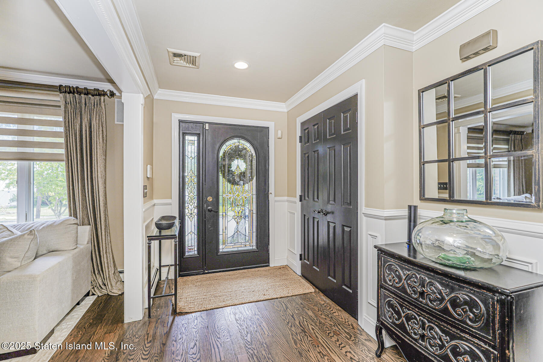 191 Rensselaer Avenue Staten Island, NY 10312 - Photo 4 of 36 a view of an entryway with wooden floor and a livingroom