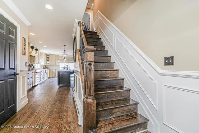 a view of a kitchen with wooden floor and electronic appliances