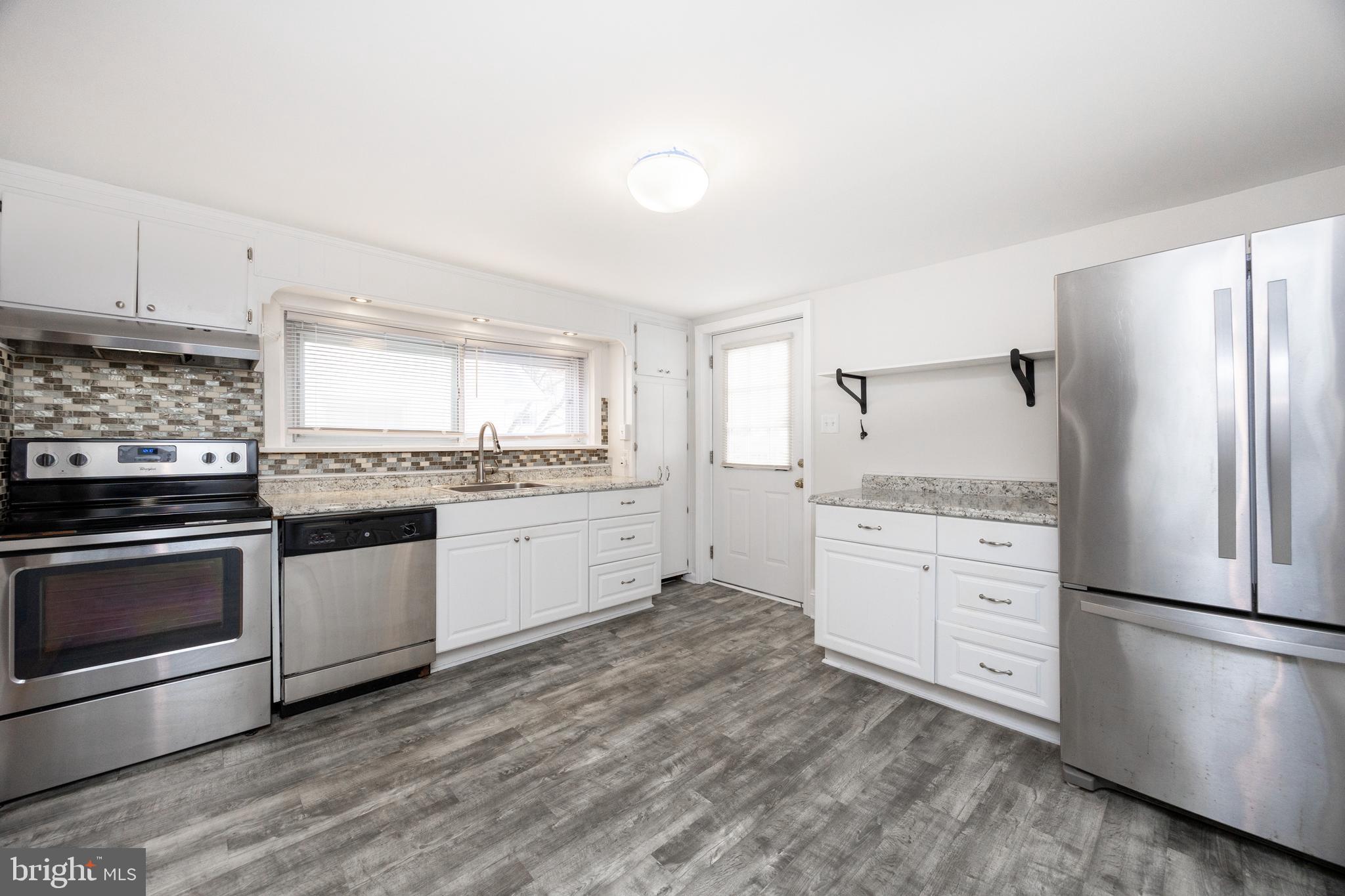 547 Northbrook Road West Chester, PA 19382 - Photo 4 of 35 a kitchen with granite countertop stainless steel appliances a refrigerator sink and cabinets