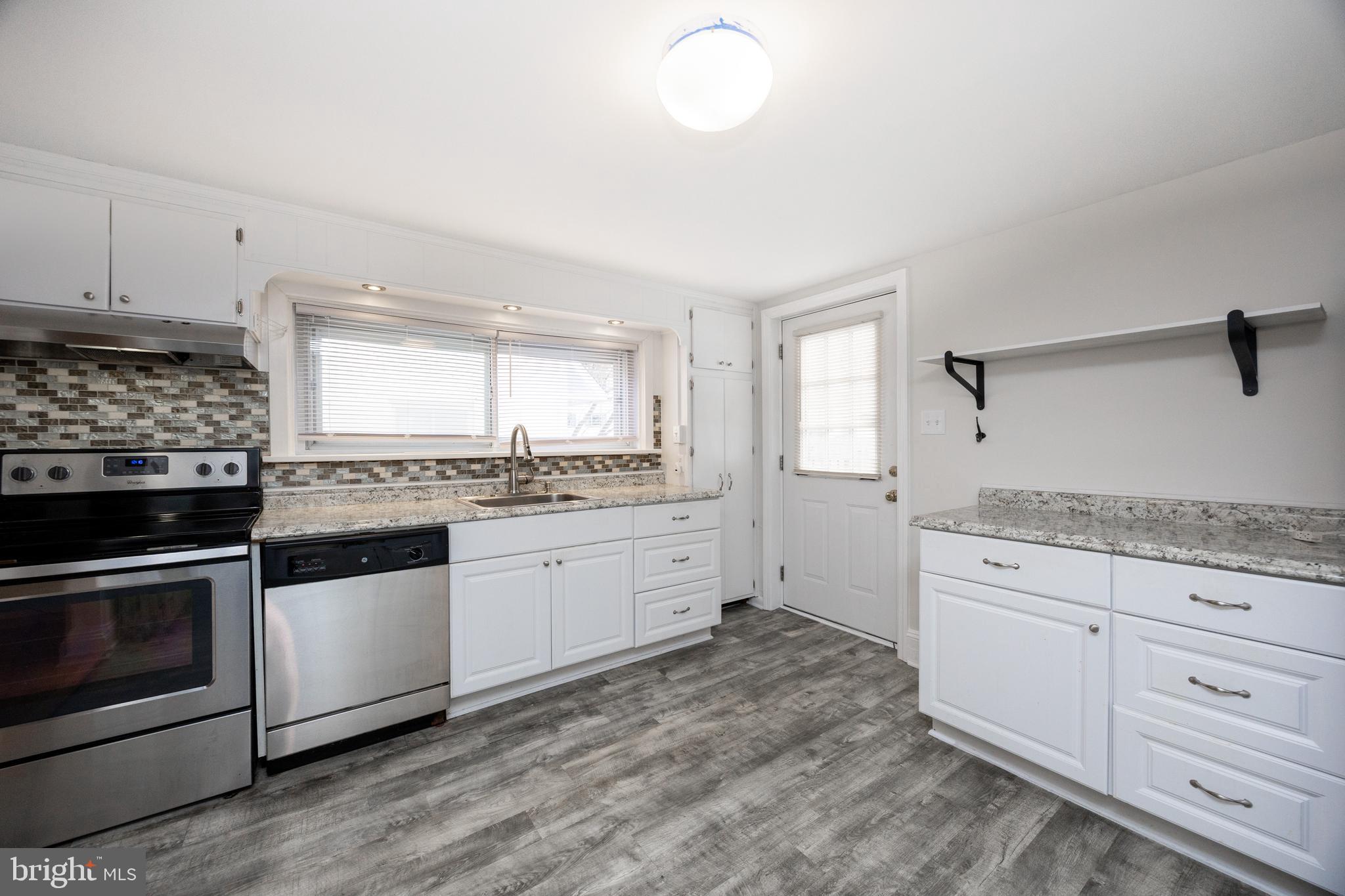 547 Northbrook Road West Chester, PA 19382 - Photo 5 of 35 a kitchen with granite countertop white cabinets and appliances