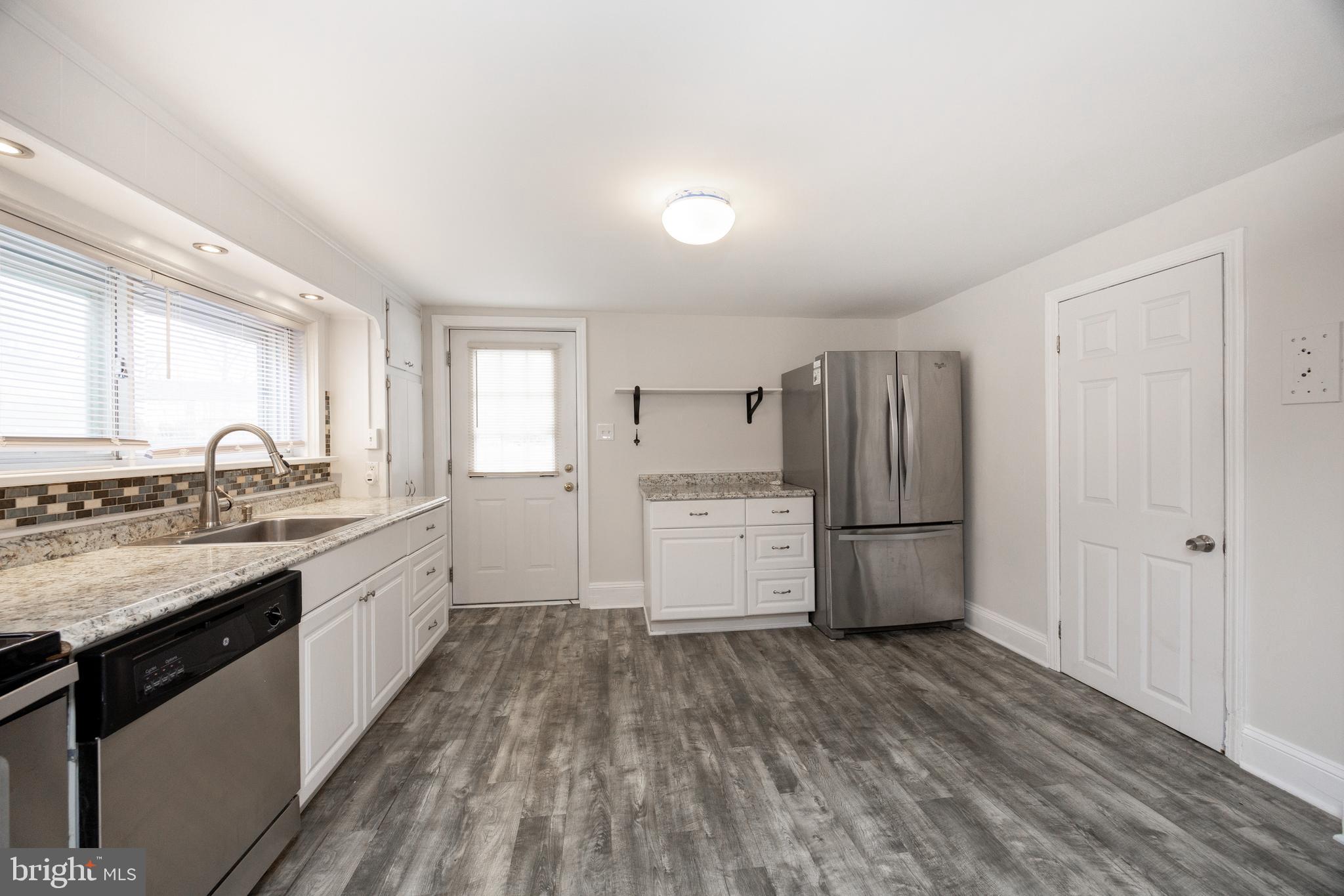 547 Northbrook Road West Chester, PA 19382 - Photo 7 of 35 a kitchen with a white cabinets and wooden floor