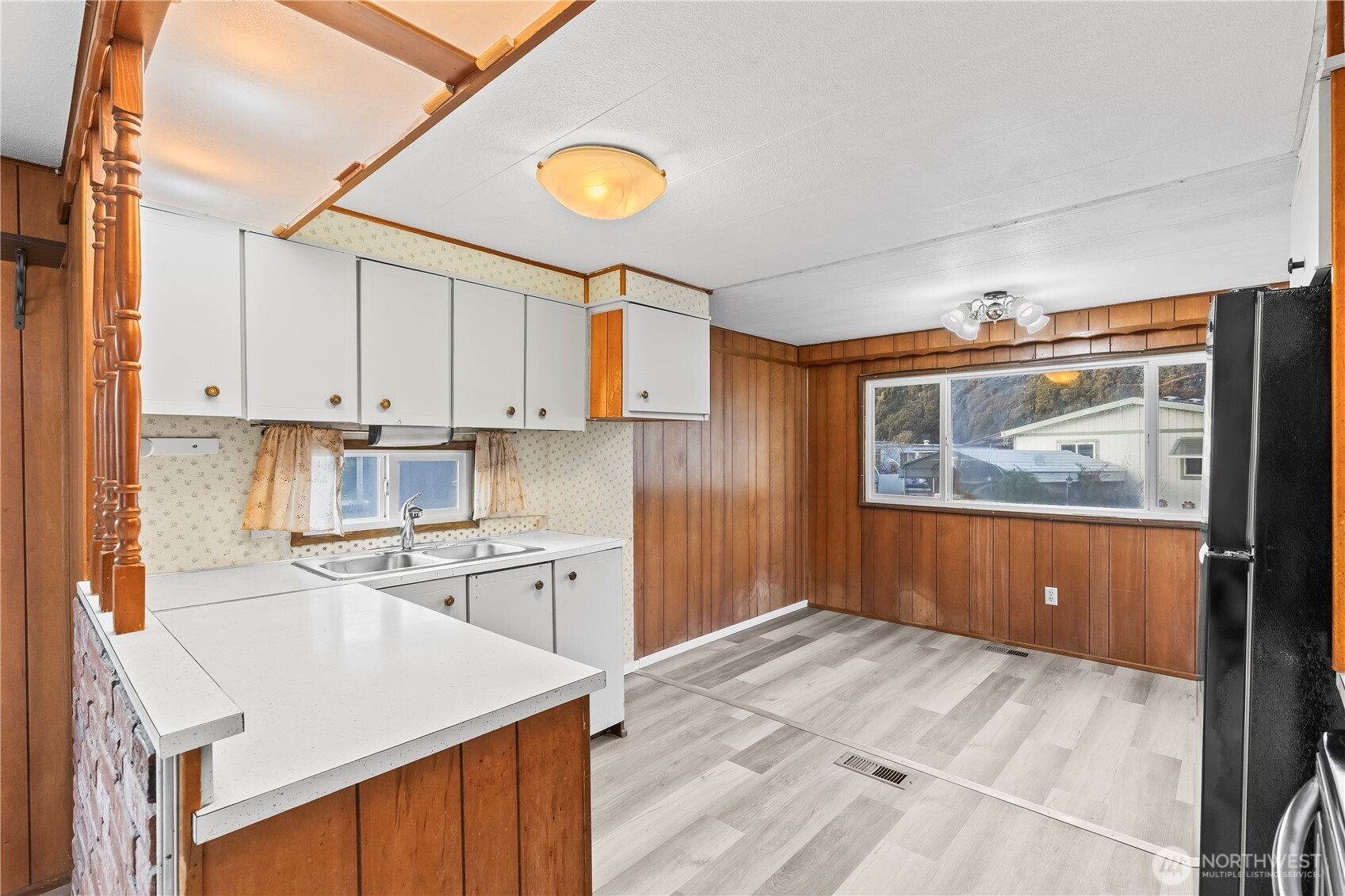 110 Sage Trail Road, Unit 13 Yakima, WA 98901 - Photo 4 of 16 a kitchen with stainless steel appliances granite countertop a refrigerator a stove and white cabinets with wooden floor