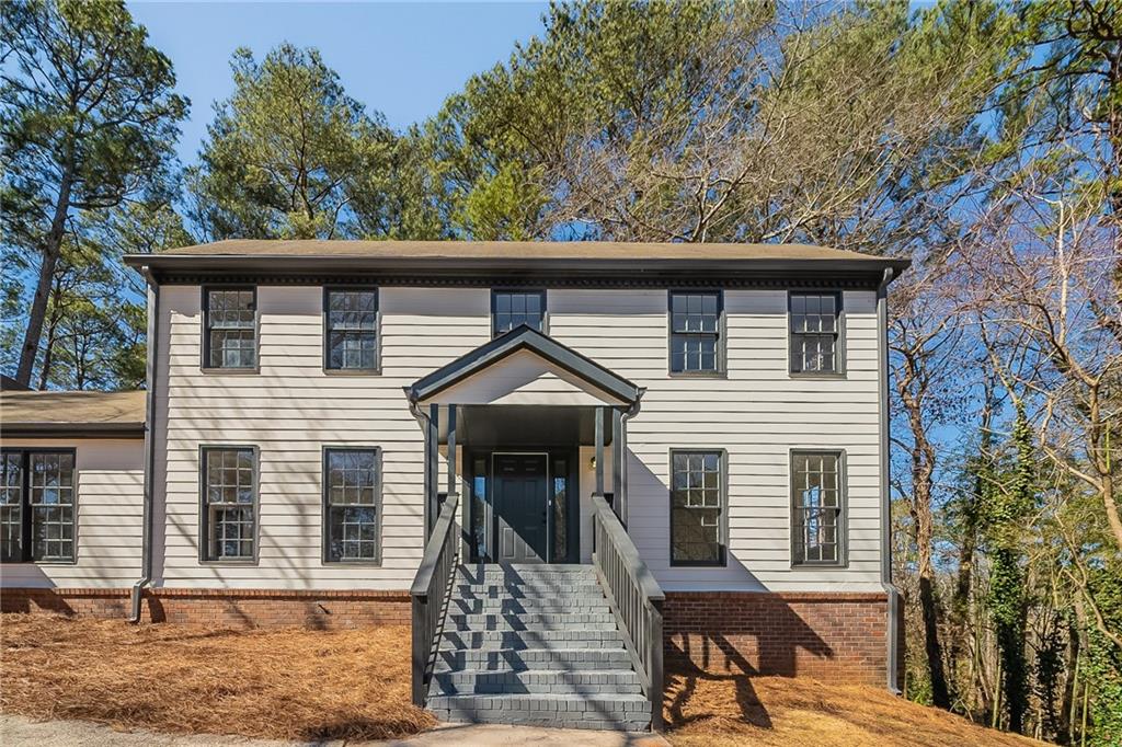3777 Clubhouse Way Southeast Conyers, GA 30094 - Photo 1 of 1 a front view of a house with garden
