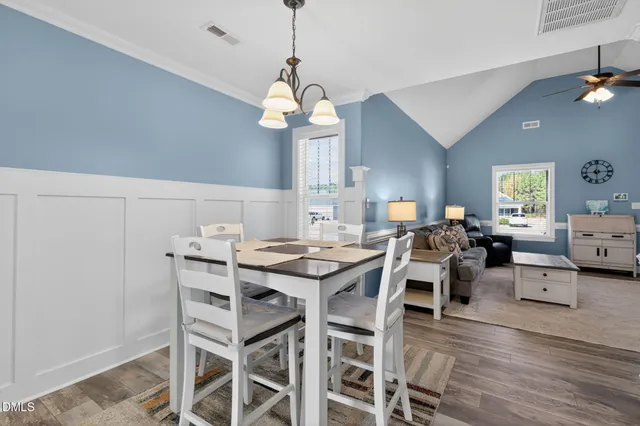 a view of a dining room with furniture wooden floor and chandelier