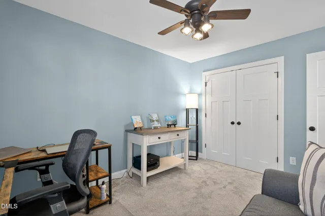 a view of a workspace with furniture and a window