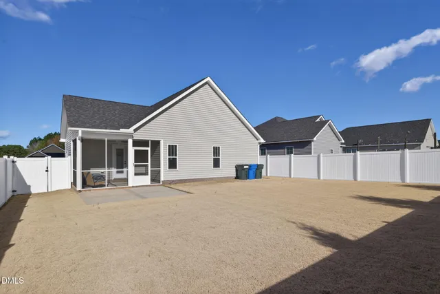 a view of house with yard and ocean view