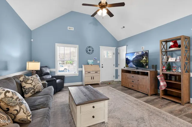 a living room with furniture and a dresser