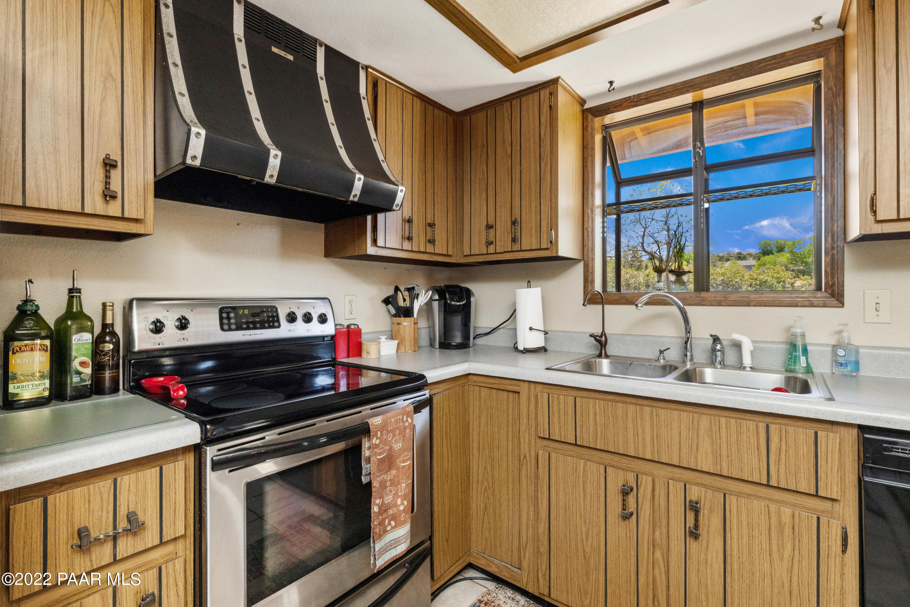 1481 West Cliff Rose Road Prescott, AZ 86305 - Photo 11 of 38 a kitchen with stainless steel appliances granite countertop a sink stove and cabinets