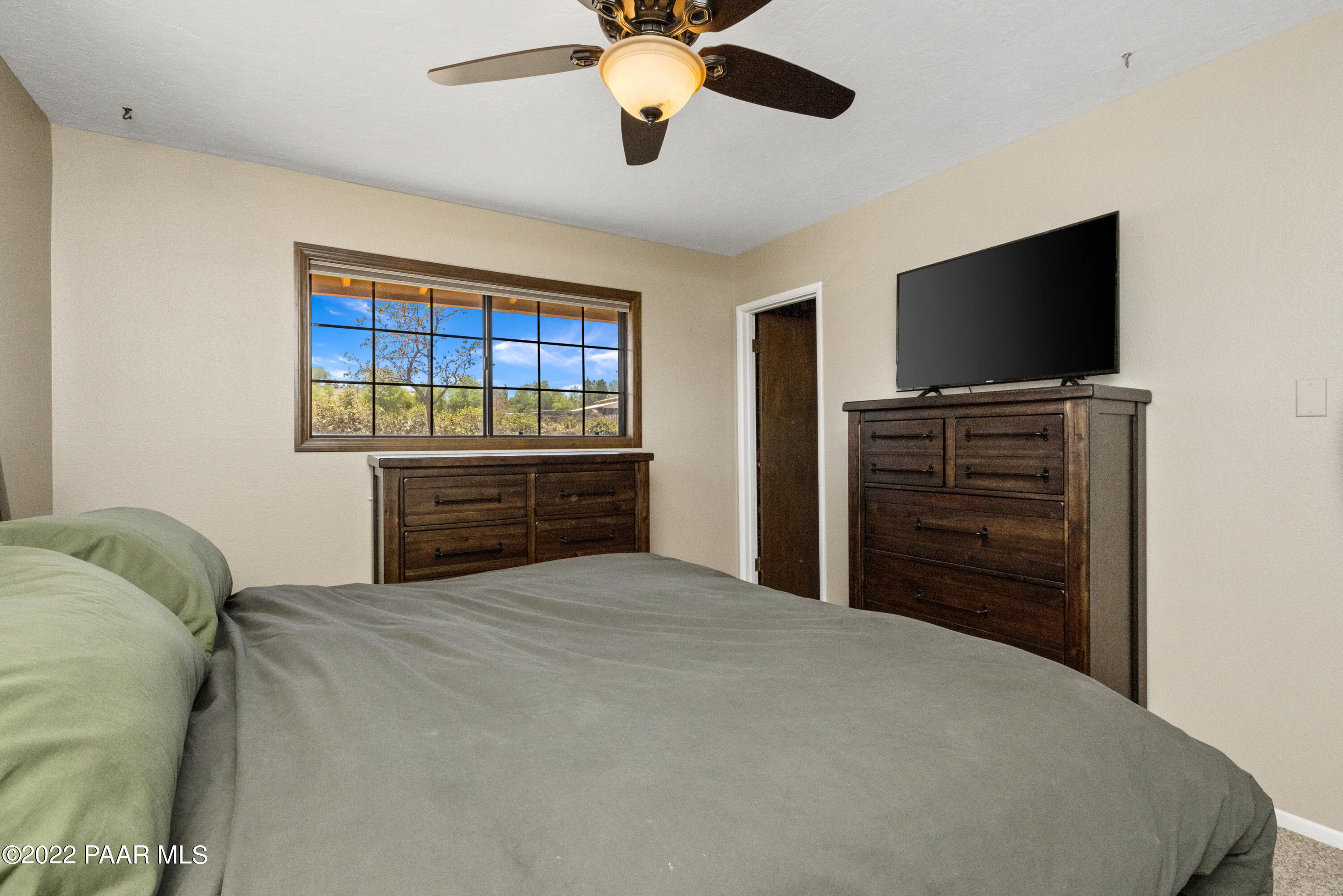 1481 West Cliff Rose Road Prescott, AZ 86305 - Photo 15 of 38 a bedroom with a bed and a flat screen tv