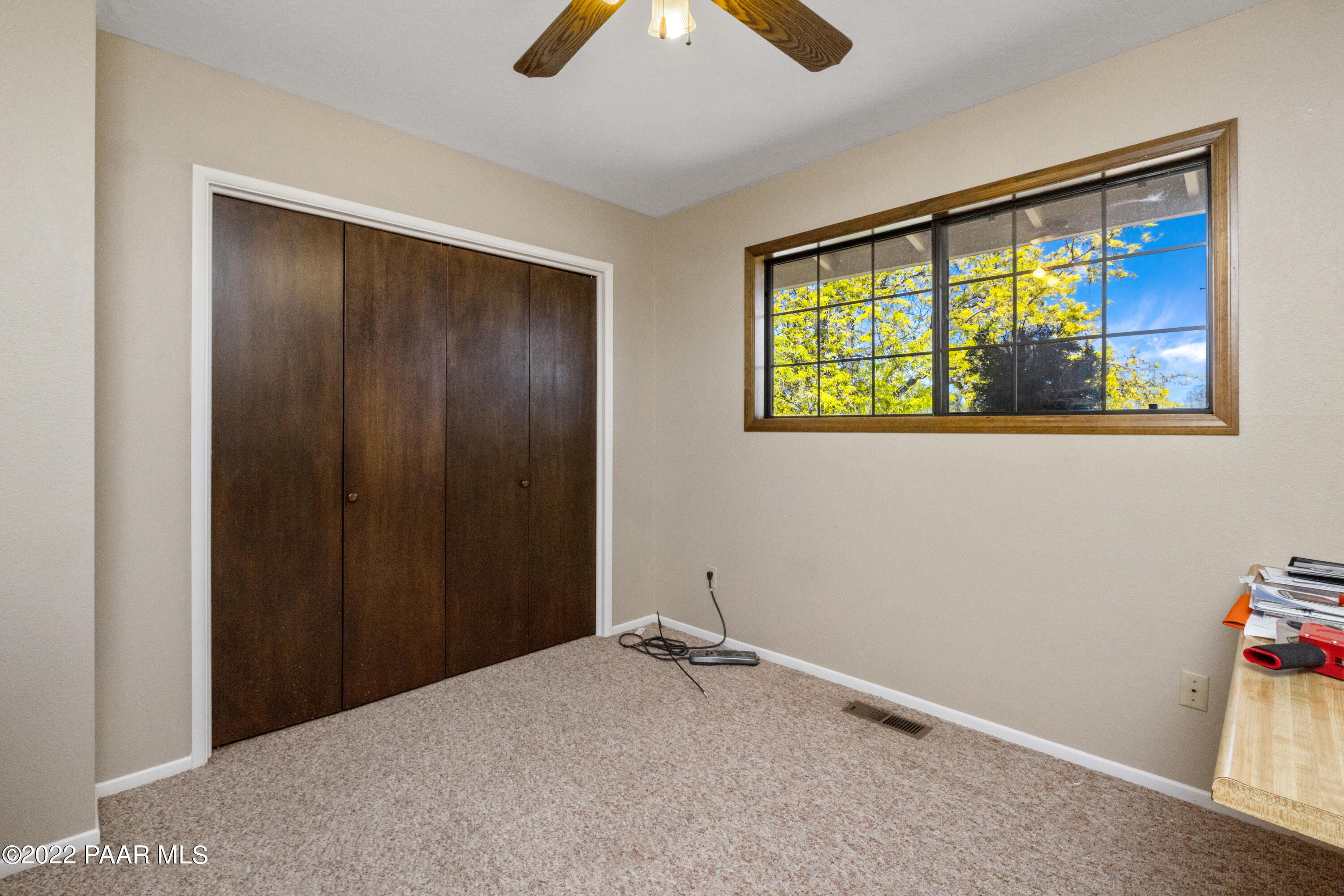 1481 West Cliff Rose Road Prescott, AZ 86305 - Photo 17 of 38 a view of an empty room with window and chandelier fan