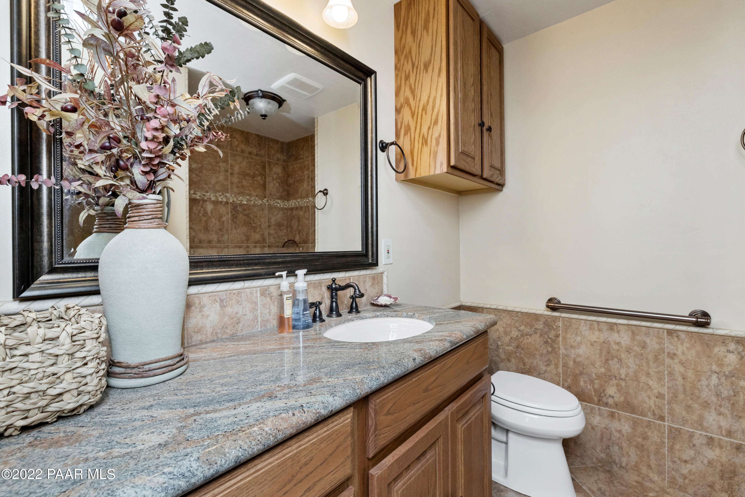 1481 West Cliff Rose Road Prescott, AZ 86305 - Photo 19 of 38 a bathroom with a granite countertop sink a toilet and mirror