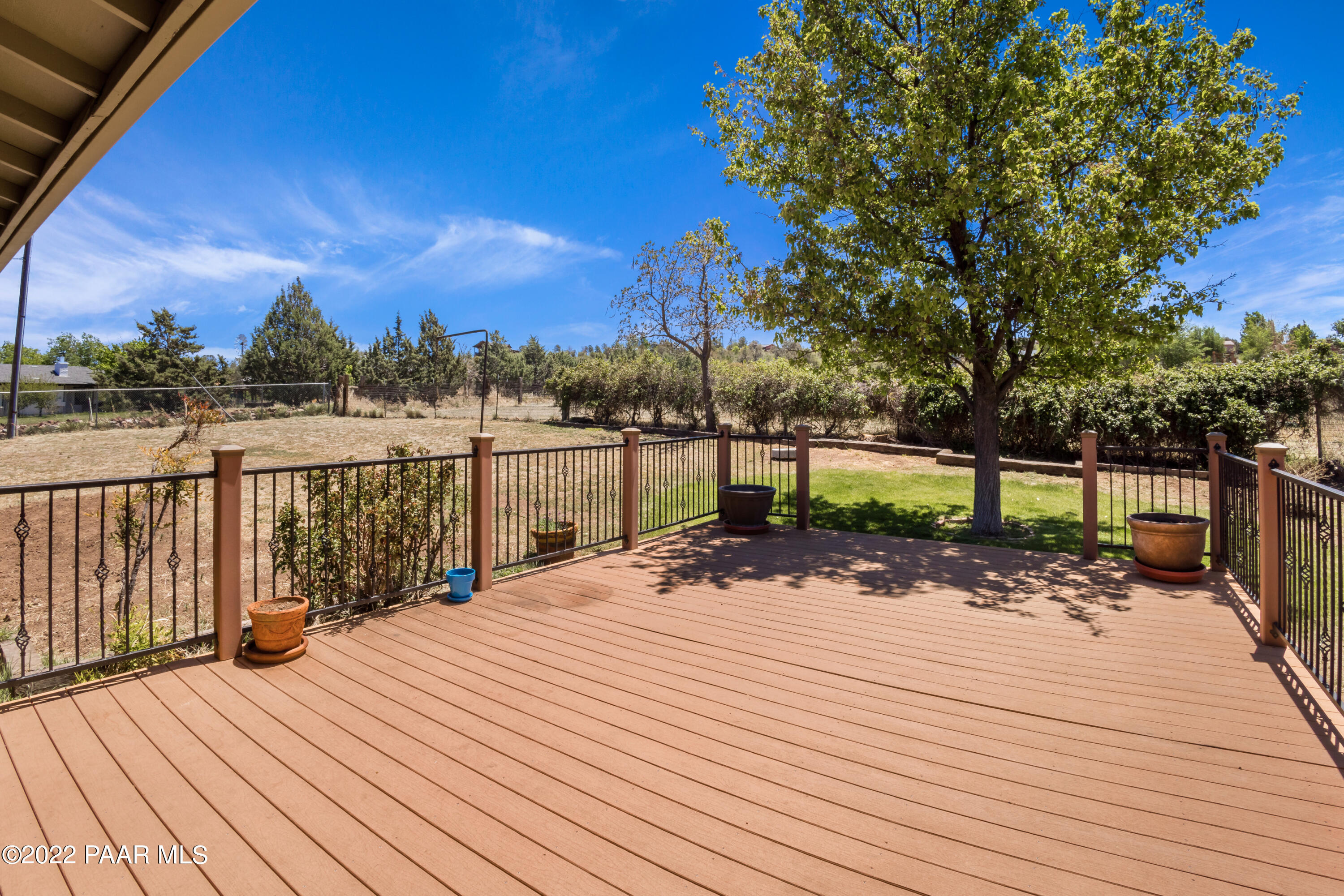 1481 West Cliff Rose Road Prescott, AZ 86305 - Photo 25 of 38 a view of a patio with a table chairs and wooden floor