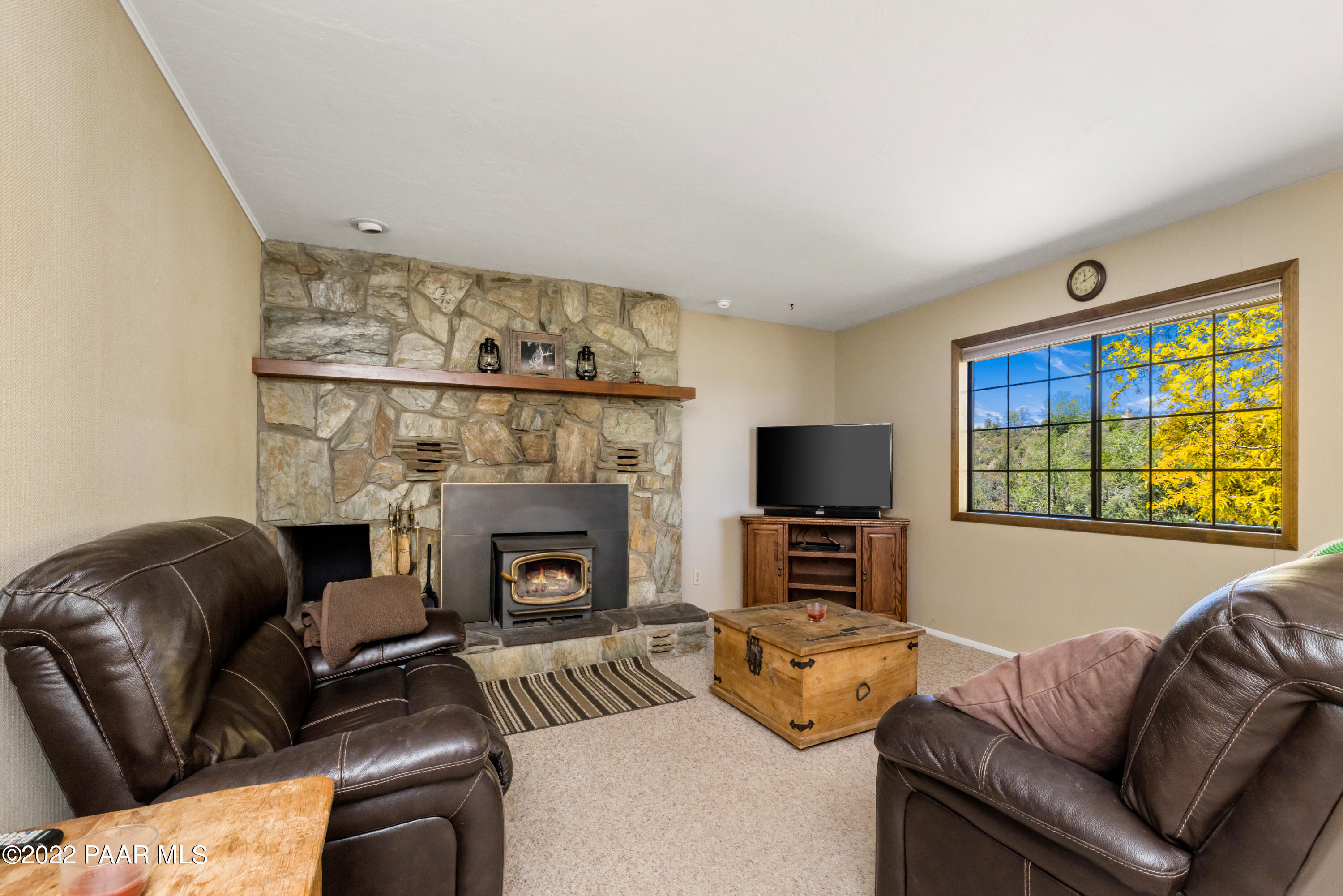 1481 West Cliff Rose Road Prescott, AZ 86305 - Photo 6 of 38 a living room with furniture a fireplace and a flat screen tv
