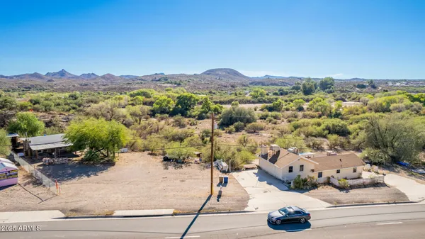 an aerial view of a house with a mountain