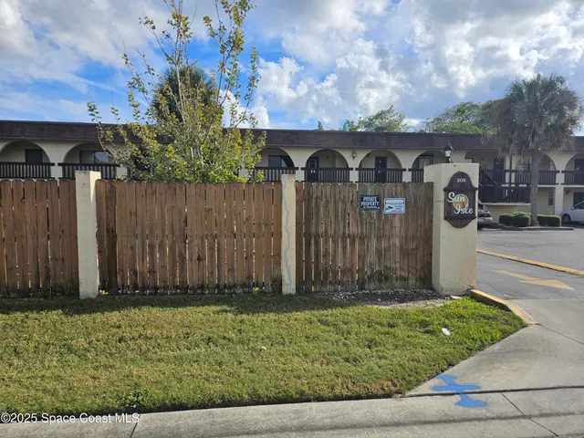 a front view of house with green space
