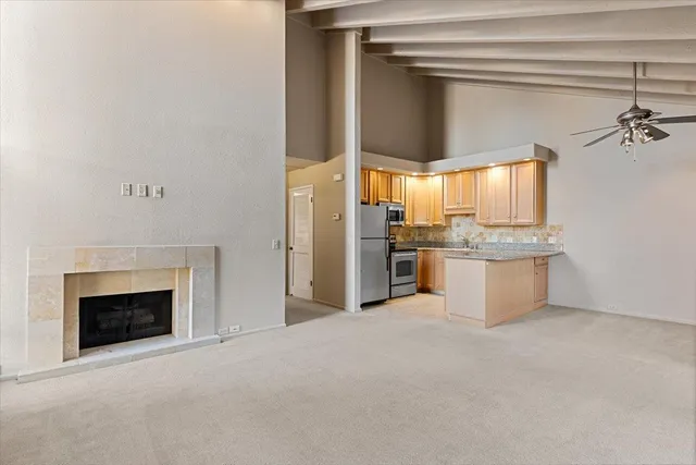 a view of a kitchen with a sink and a fireplace