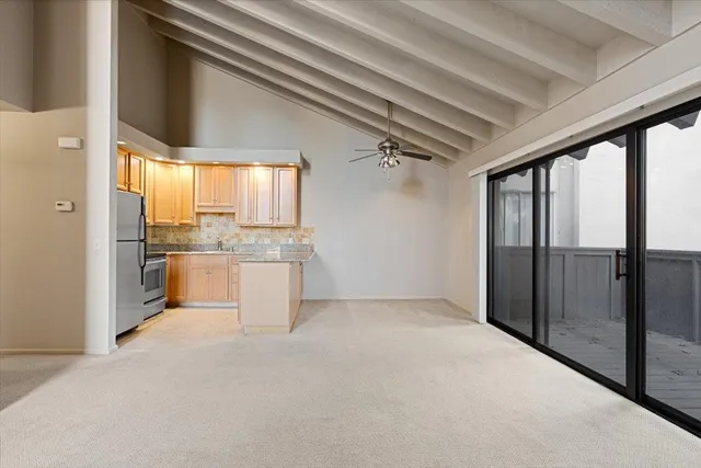 a view of a kitchen with a sink and cabinets