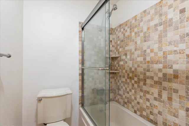 a bathroom with a shower and a toilet