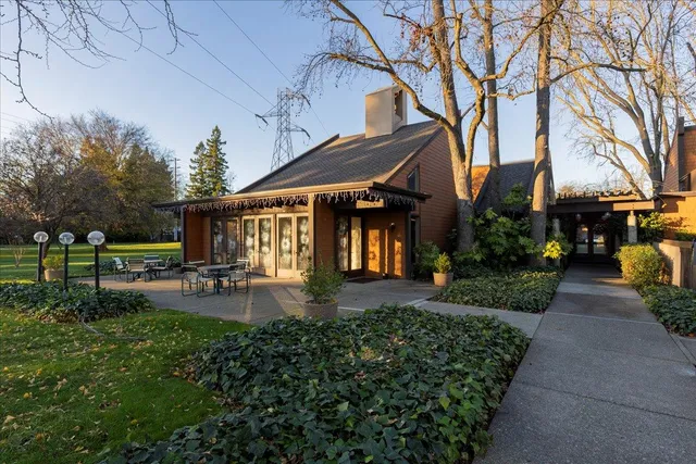 a view of a house with backyard porch and sitting area