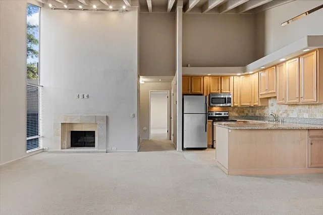 a kitchen with refrigerator a stove and a window
