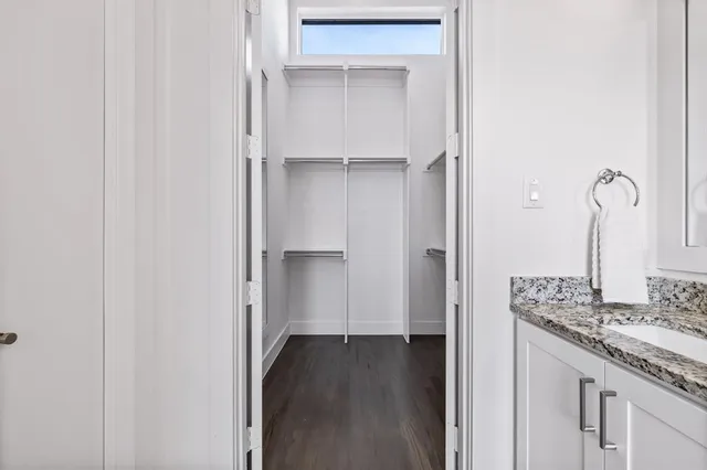 a view of a kitchen from the hallway with a sink